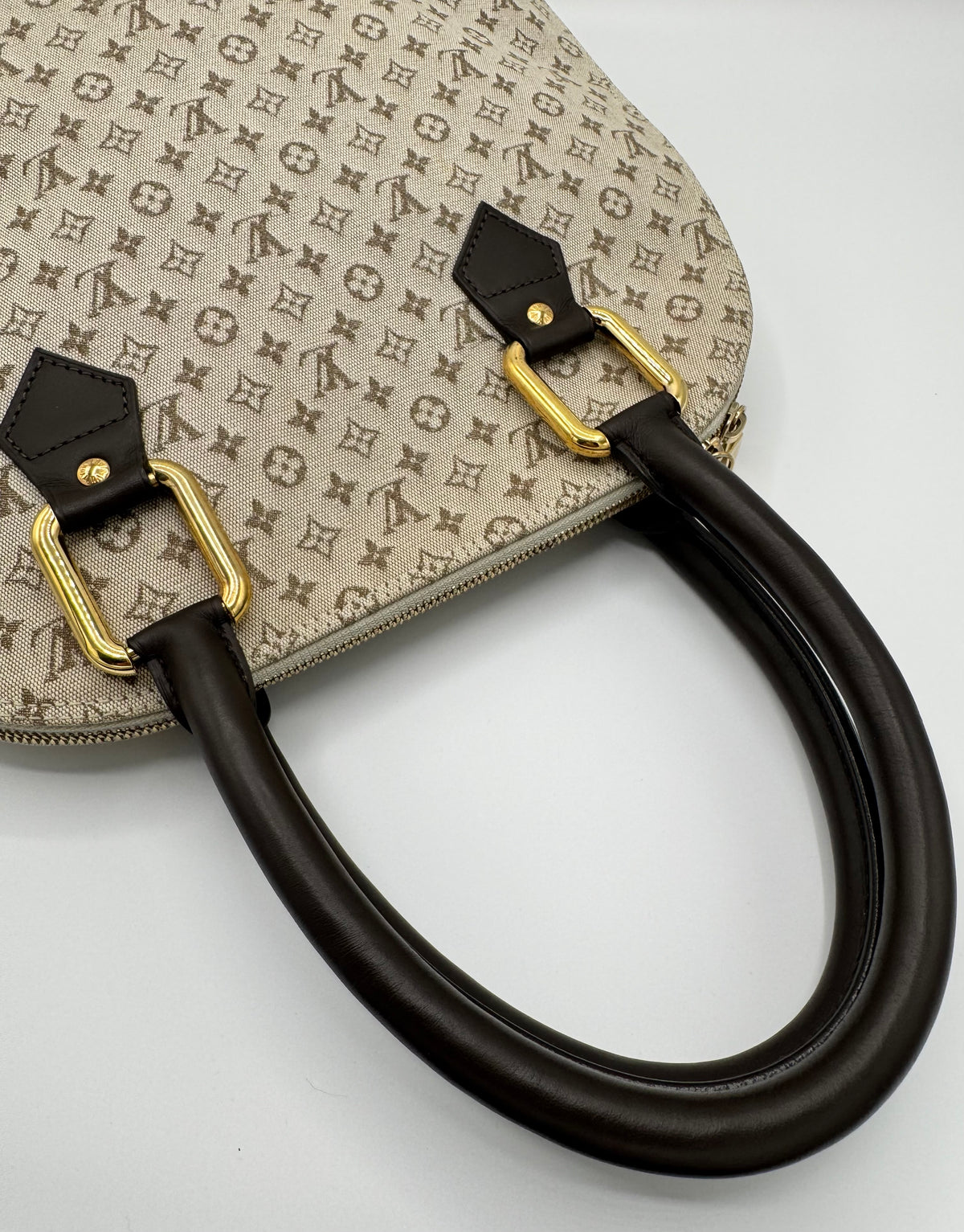 Louis Vuitton Alma in Mini Lin monogram canvas met bruine leren handvatten